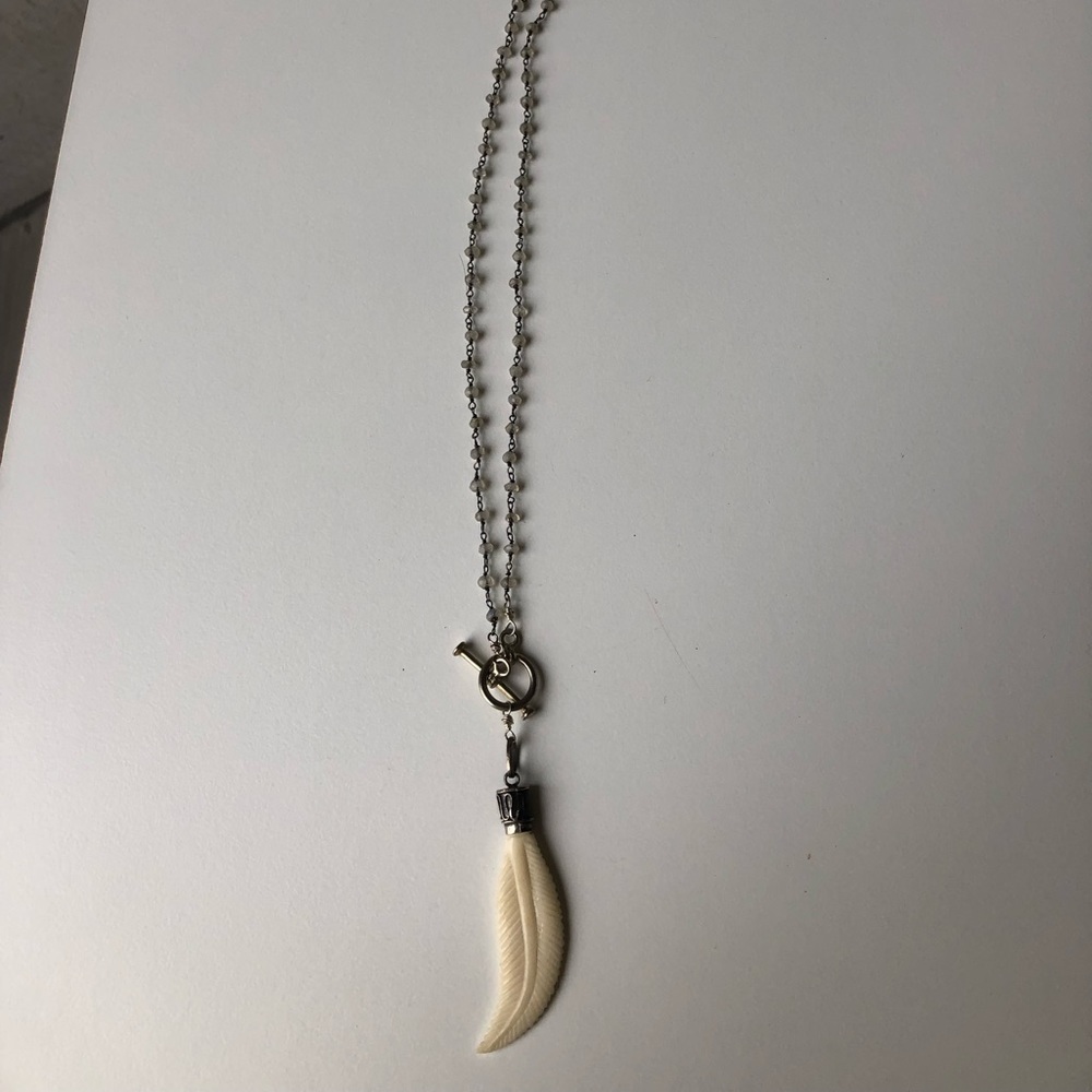 white beaded necklace with white leaf pendant